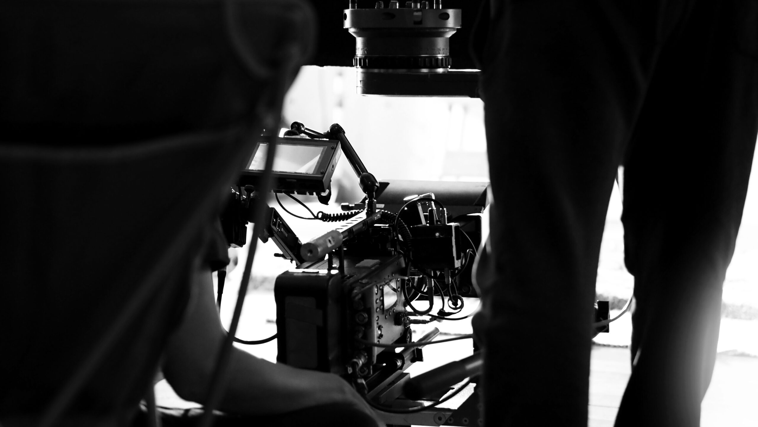 Behind the scenes of video production in studio which filming a online movie with professional set up such as high definition vdo camera, lens, monitor or tripod and crane beside crew team.
